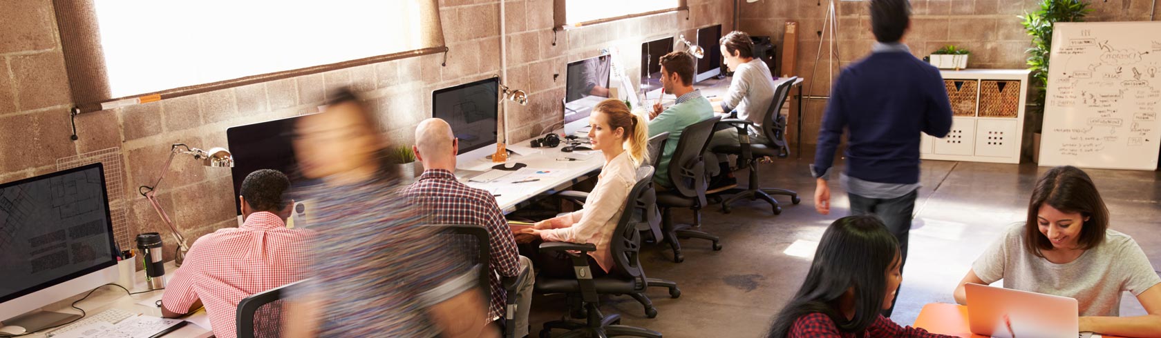 View Of Workers In Busy Modern Design Office